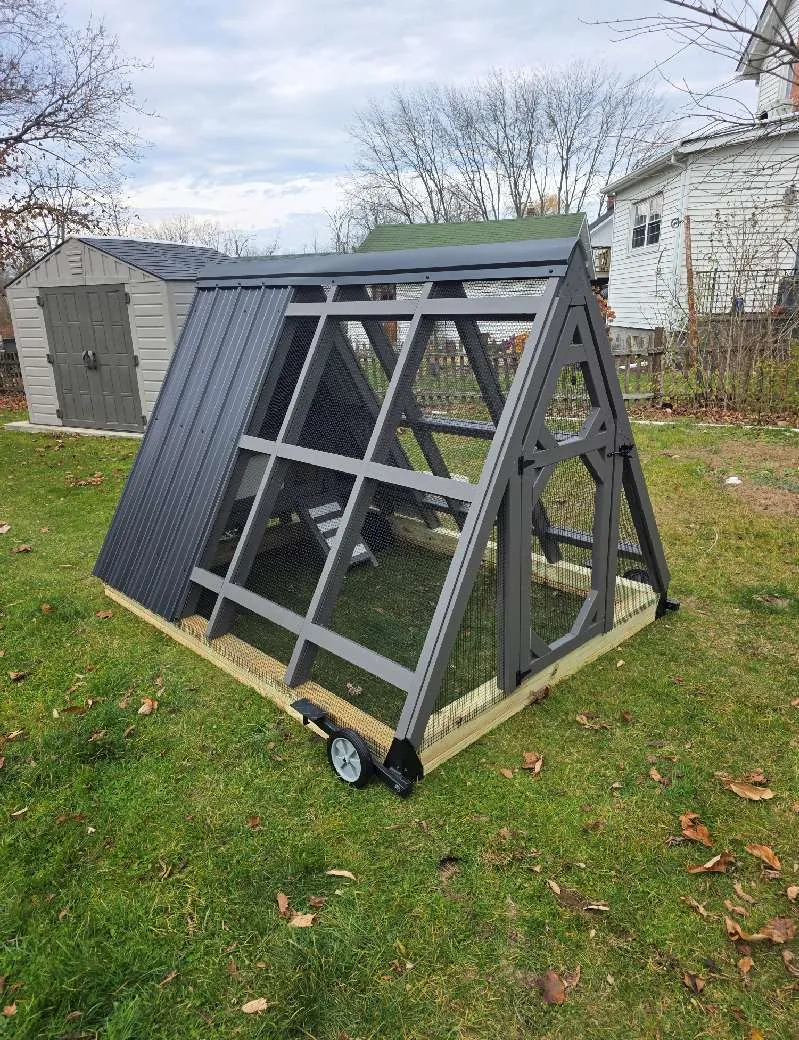 An A-frame mobile chicken tractor on wheels, built on-site by Triano Farms in New Jersey