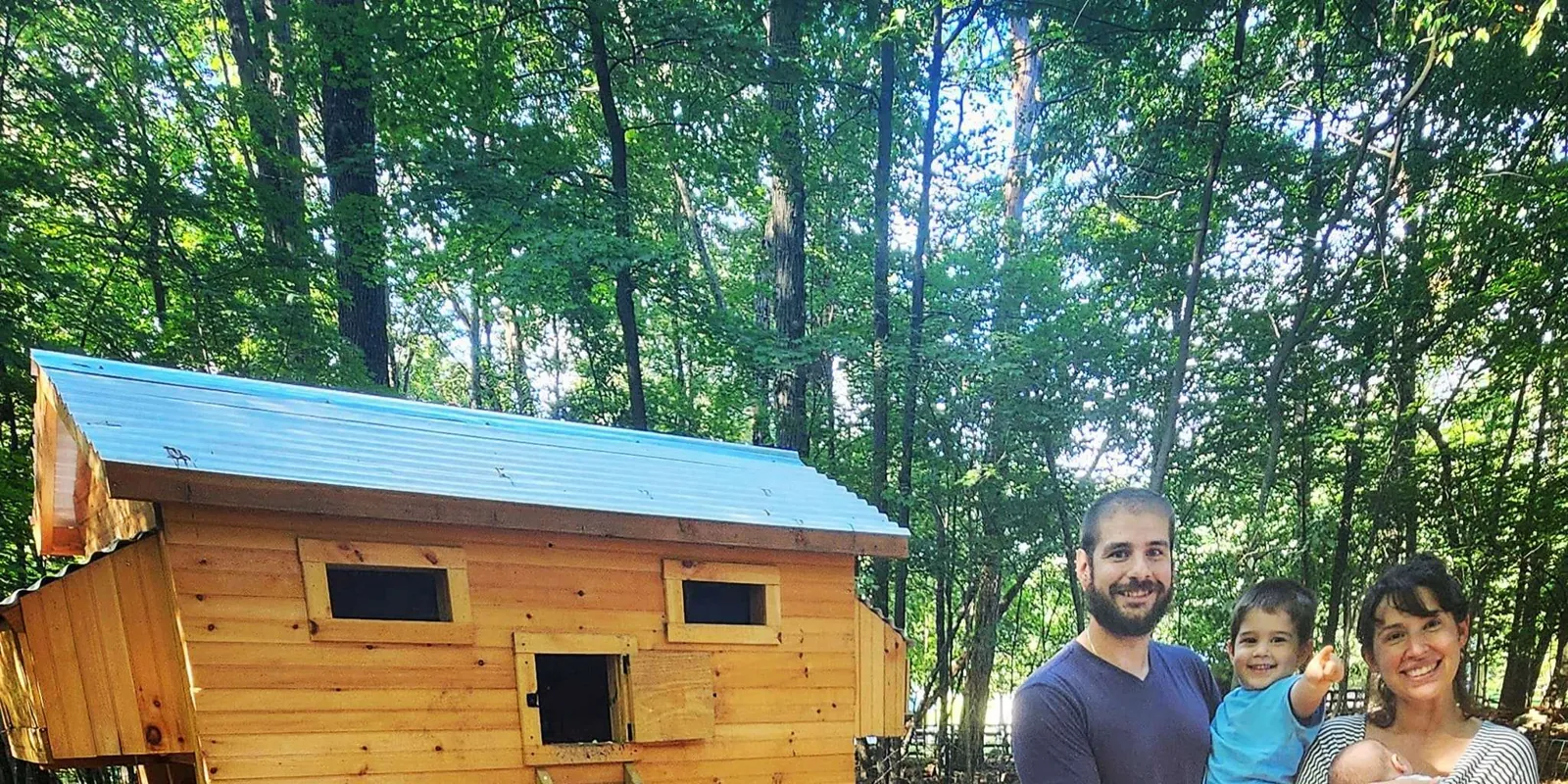 Joe Triano and his family beside the very first chicken coop he built, in the New Jersey woods